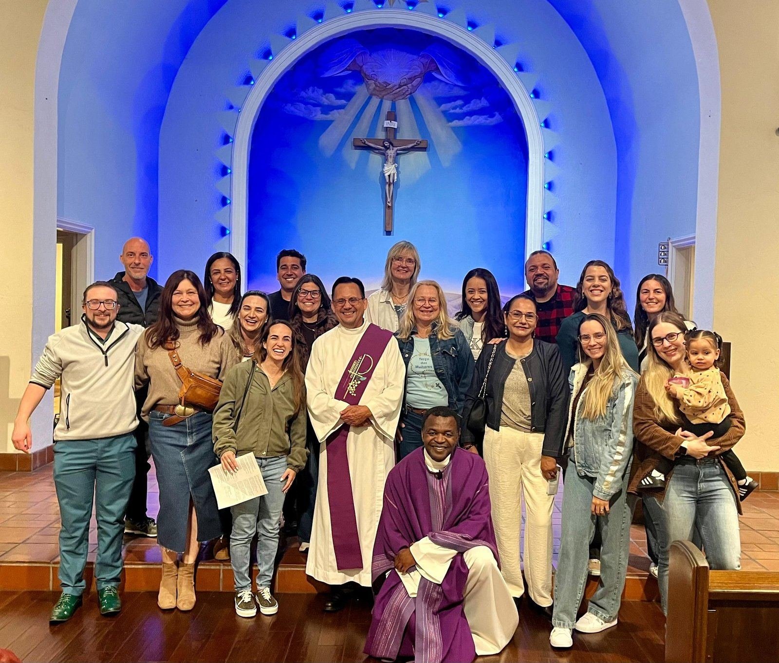 Members of the community with the deacon and the priest at the altar of Saint Agnes
